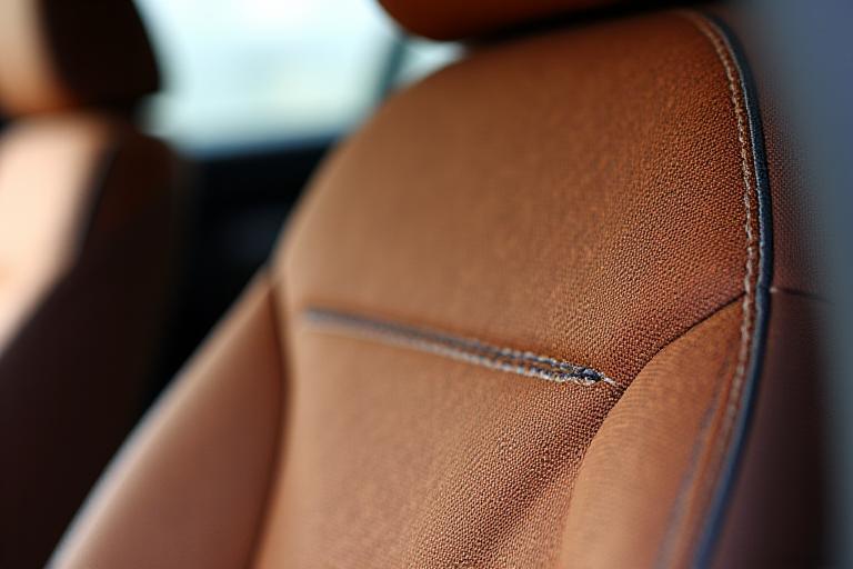 Close up of custom woven textile car seats with heavy stitching